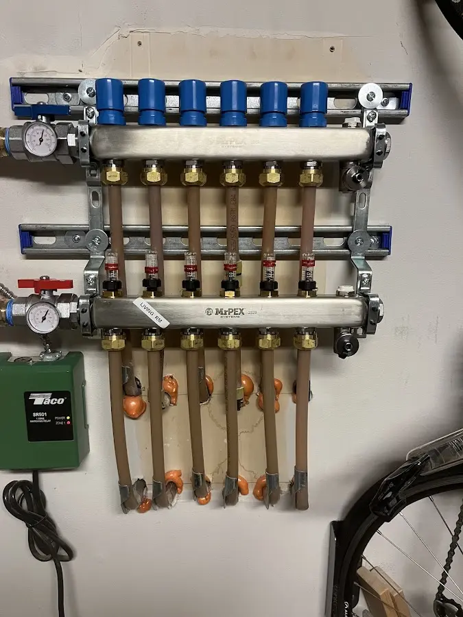 Plumber performing Water Heater Repair at a residential property in Victor